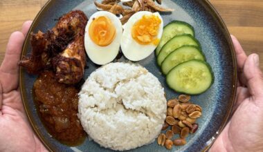 Nasi Lemak, a Malaysian local dish. Coconut rice infused with Pandan, homemade sambal, spiced chicken, boiled eggs, fried anchovies, cucumber and toasted nuts.