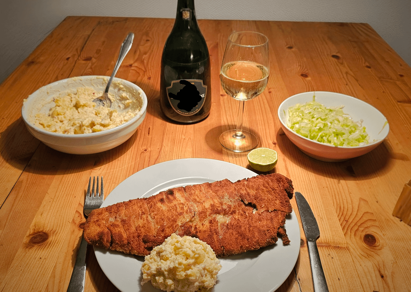 Baked Waldviertel organic carp fillet with homemade potato-mayonnaise salad and champagne.