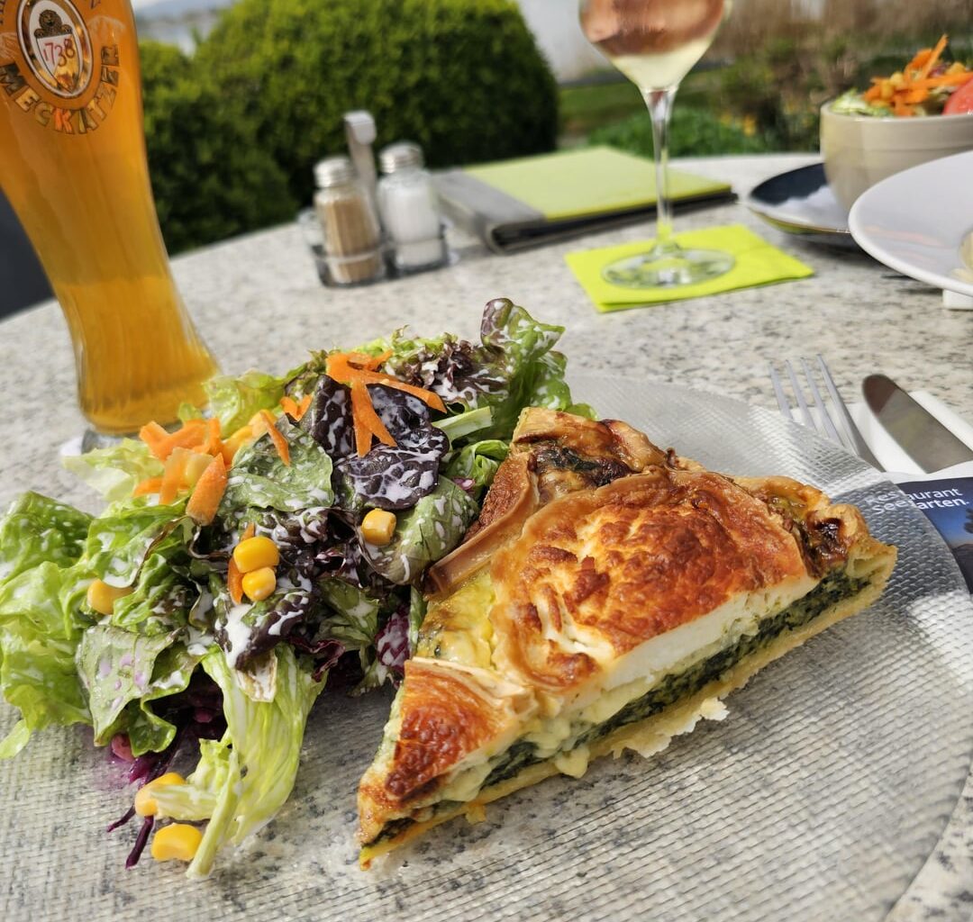 Homemade spinach quiche with goat's cheese and mixed salad, served in Allensbach (Germany)
