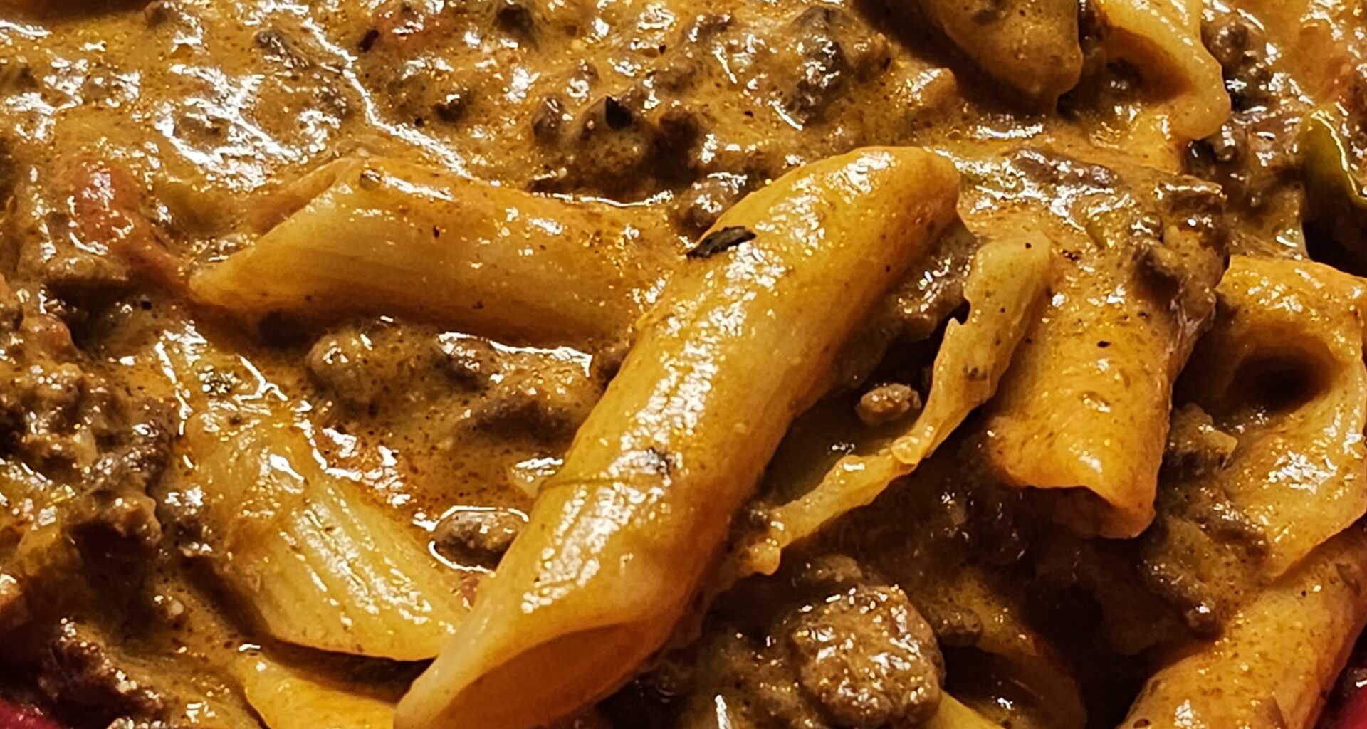 Penne with slow-cooked ragù (hashed beef with veggies)