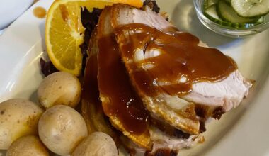 Danish style roast pork with boiled potatoes, red cabbage, and cucumber salad in Copenhagen