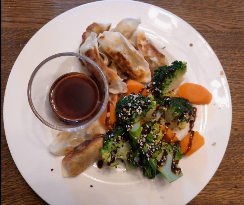 Vegetarian dumplings with soy and rice wine vinegar dipping sauce, steamed broccoli and carrot with hoi sin, garlic, salt and sesame seeds.