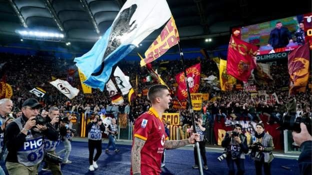 Roma defender Gianluca Mancini faces an investigation after waving a flag depicting Lazio fans as "rats"