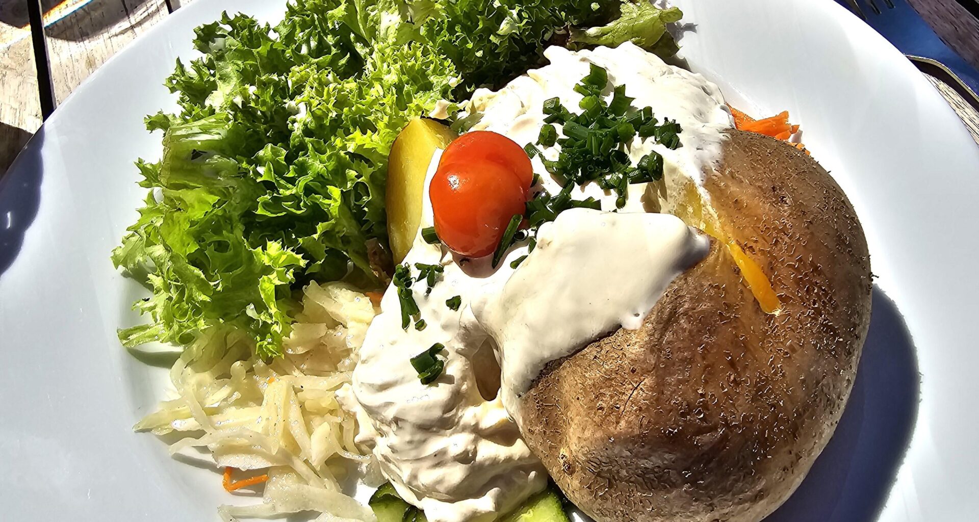 Hot jacket potato with sour cream and mixed salad