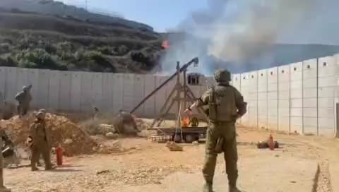 IDF soldiers use a trebuchet to light fires on the Lebanese side of the border