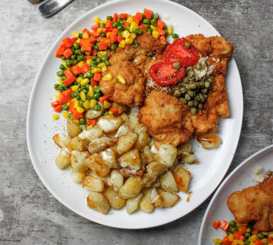 Pork Schnitzel topped with freshly grated horseradish & capers, served with butter sautéed vegetables & roasted potatoes w. Cream sauce