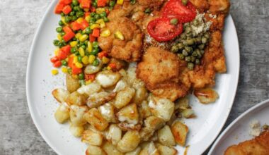 Pork Schnitzel topped with freshly grated horseradish & capers, served with butter sautéed vegetables & roasted potatoes w. Cream sauce