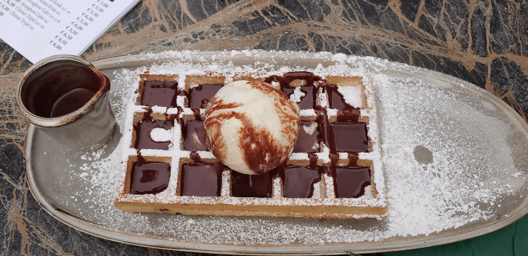 Belgian waffle with warm chocolate sauce in Bruges