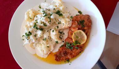 Breading chicken breast in parmesan cheese, lemon butter sauce and chilli.Cauliflower in cheese sauce