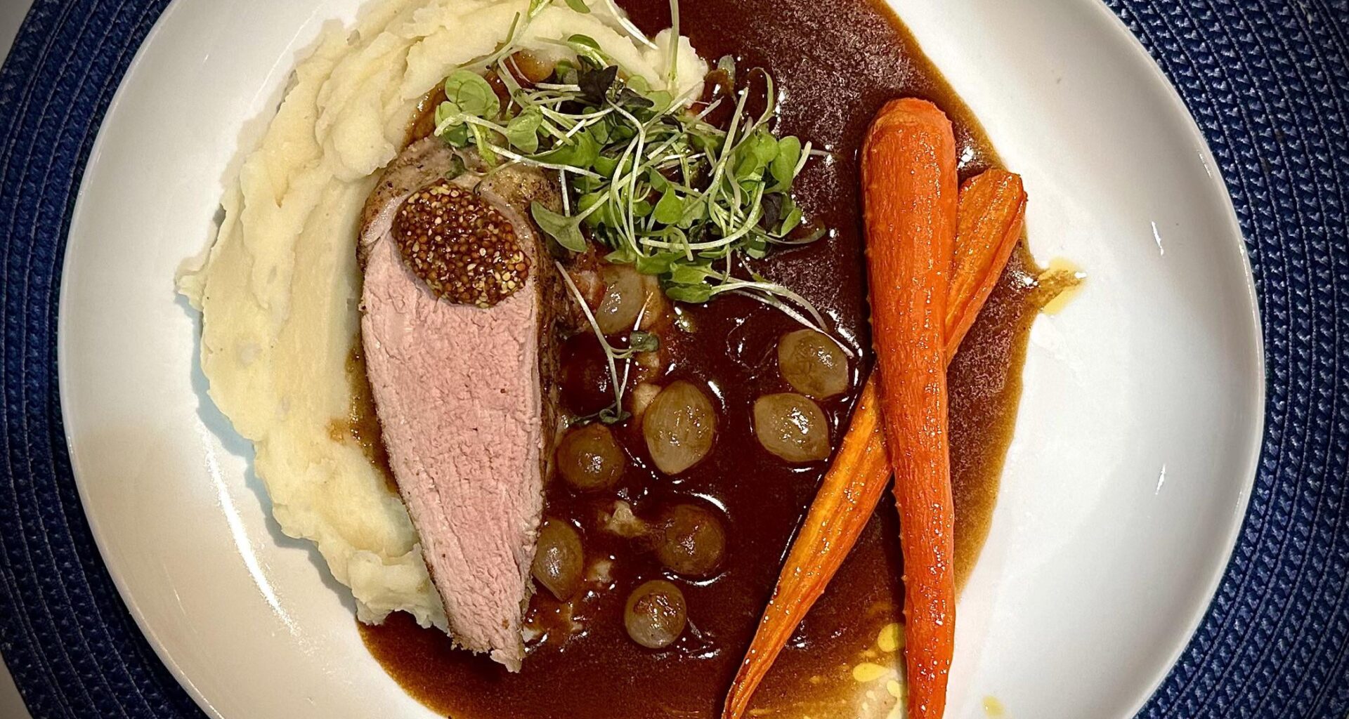 Pork tenderloin, whipped potatoes, red wine sauce with pearl onions & carrots glazed in maple syrup & lemon
