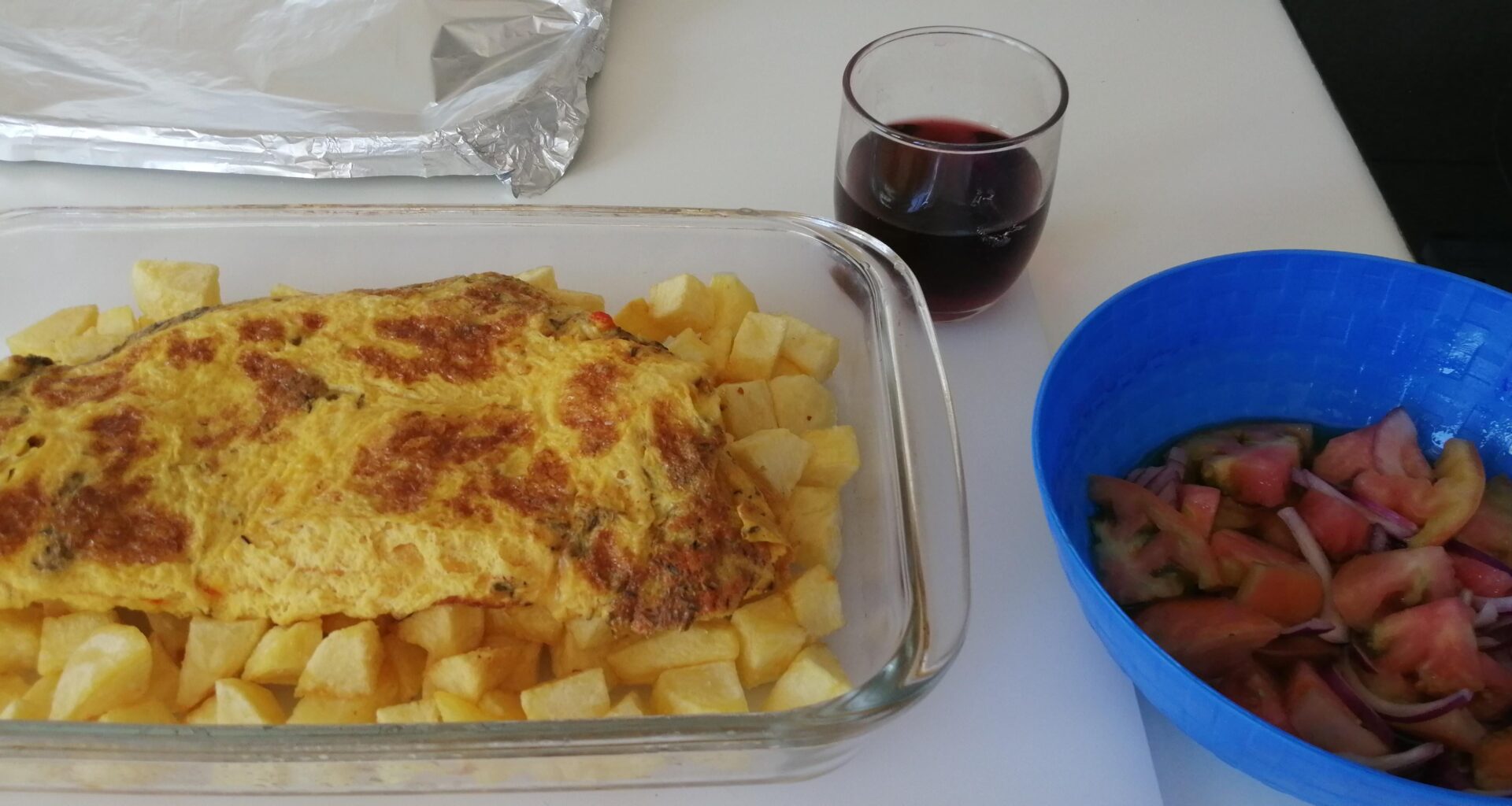 Cooking fried potatoes and a cheese omelette for 2 with a small tomato & onion side salad