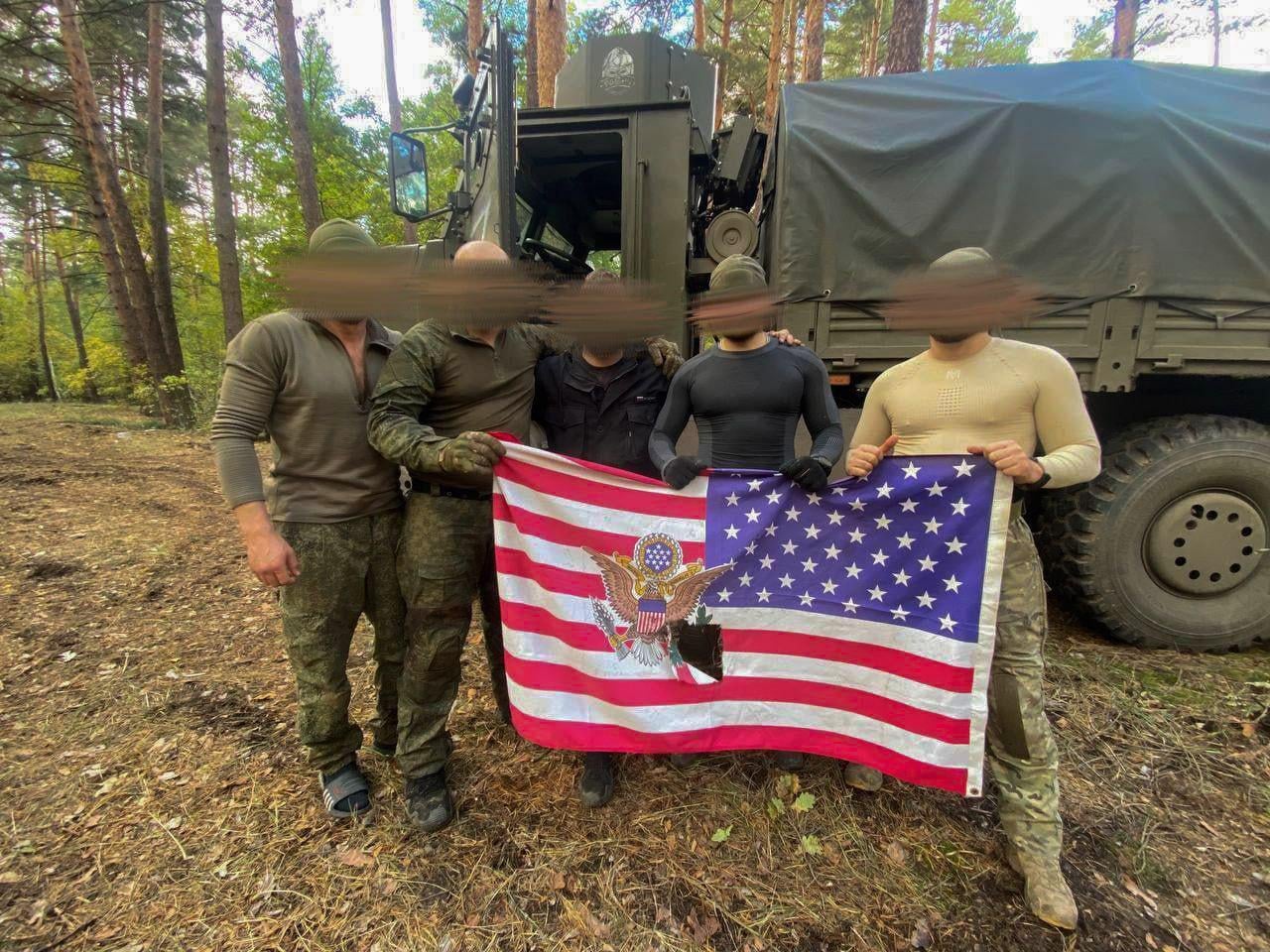 Russian soldiers with an caputerd US flag after an fight with amarican soldiers in ukranie