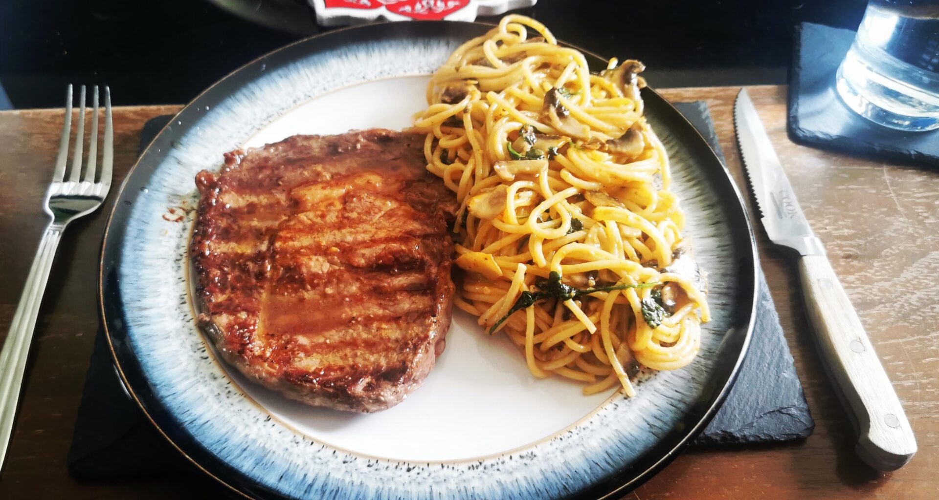 [Homemade] ribeye steak medium, finished with garlic butter, spinach and mushroom spaghetti finished with cream, tomato, mozzarella and truffle oil sauce