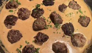 Swedish meatballs with creamy mashed potatoes and buttered green beans .