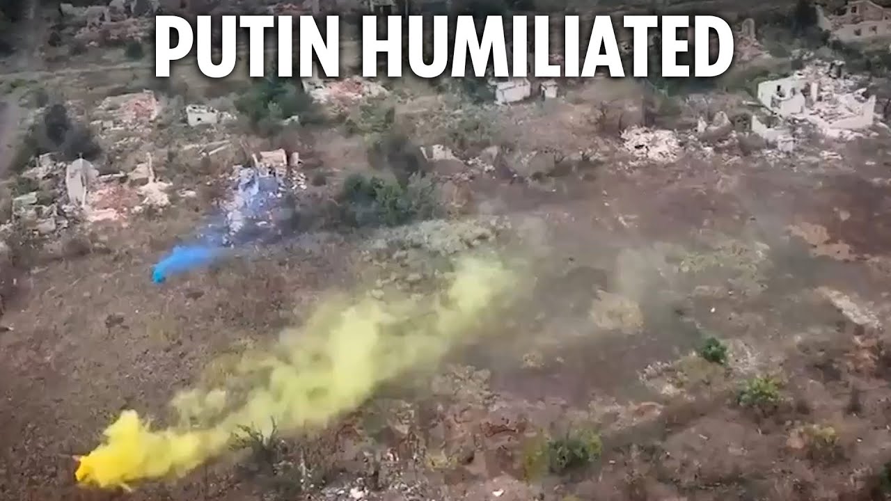 Ukrainian troops raise their flag after taking land back from Russians in blitz