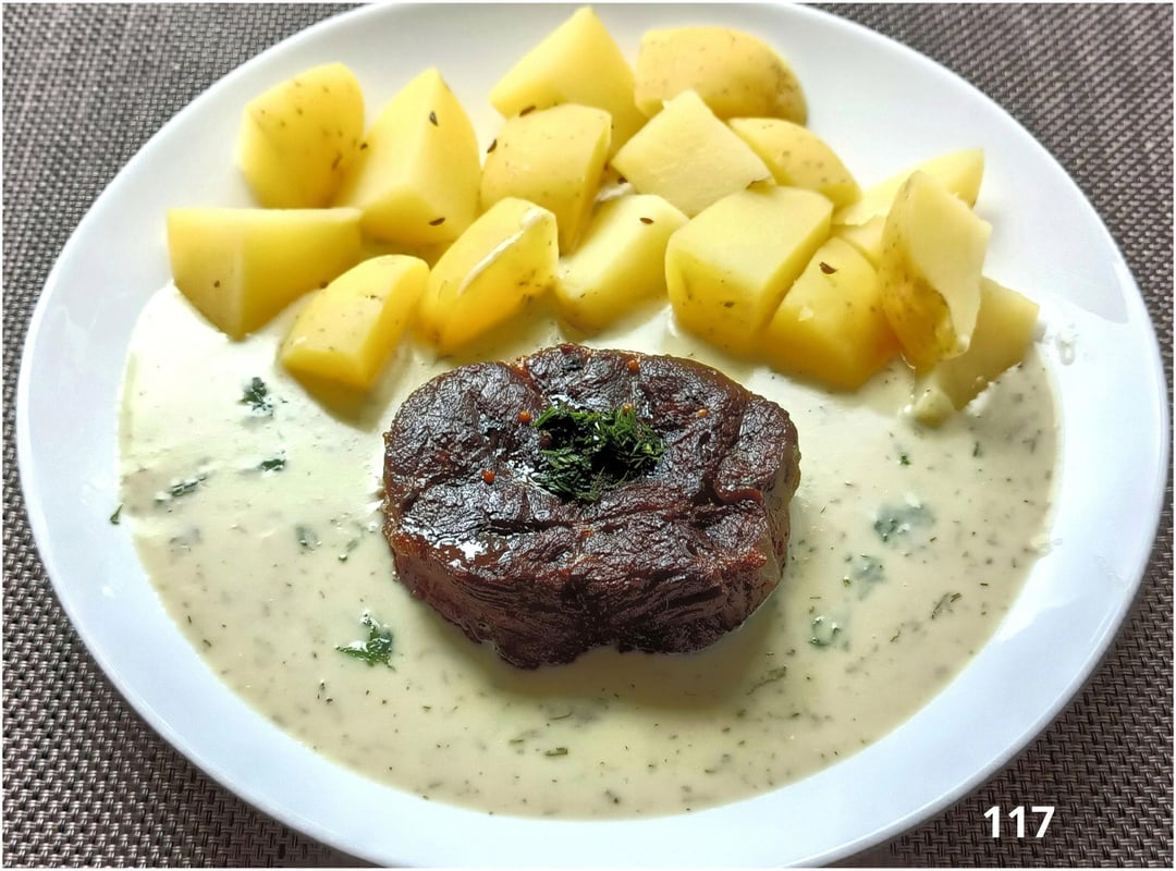 Beef tenderloin, new potatoes and dill sauce with cream.