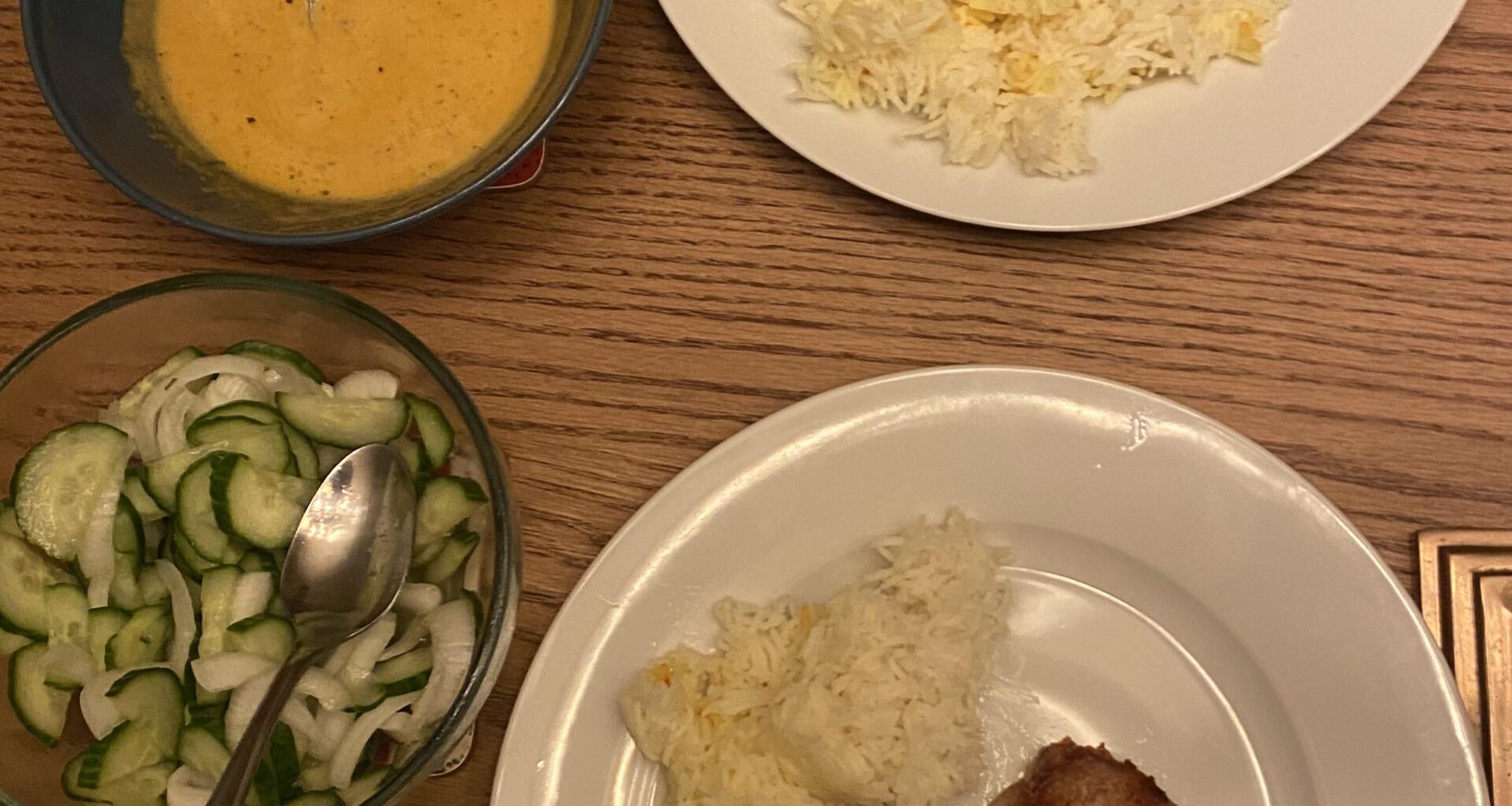 pork cutlet, saffron rice, japanese-inspired curry sauce, cucumber salad