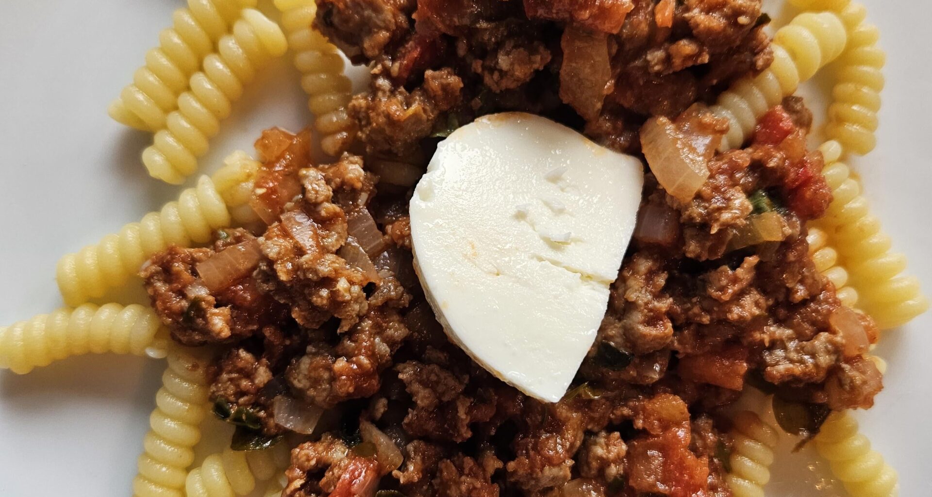 Pasta with a sauce made of veal mince, onions, garlic, homegrown basil and oregano, and homegrown tomatoes