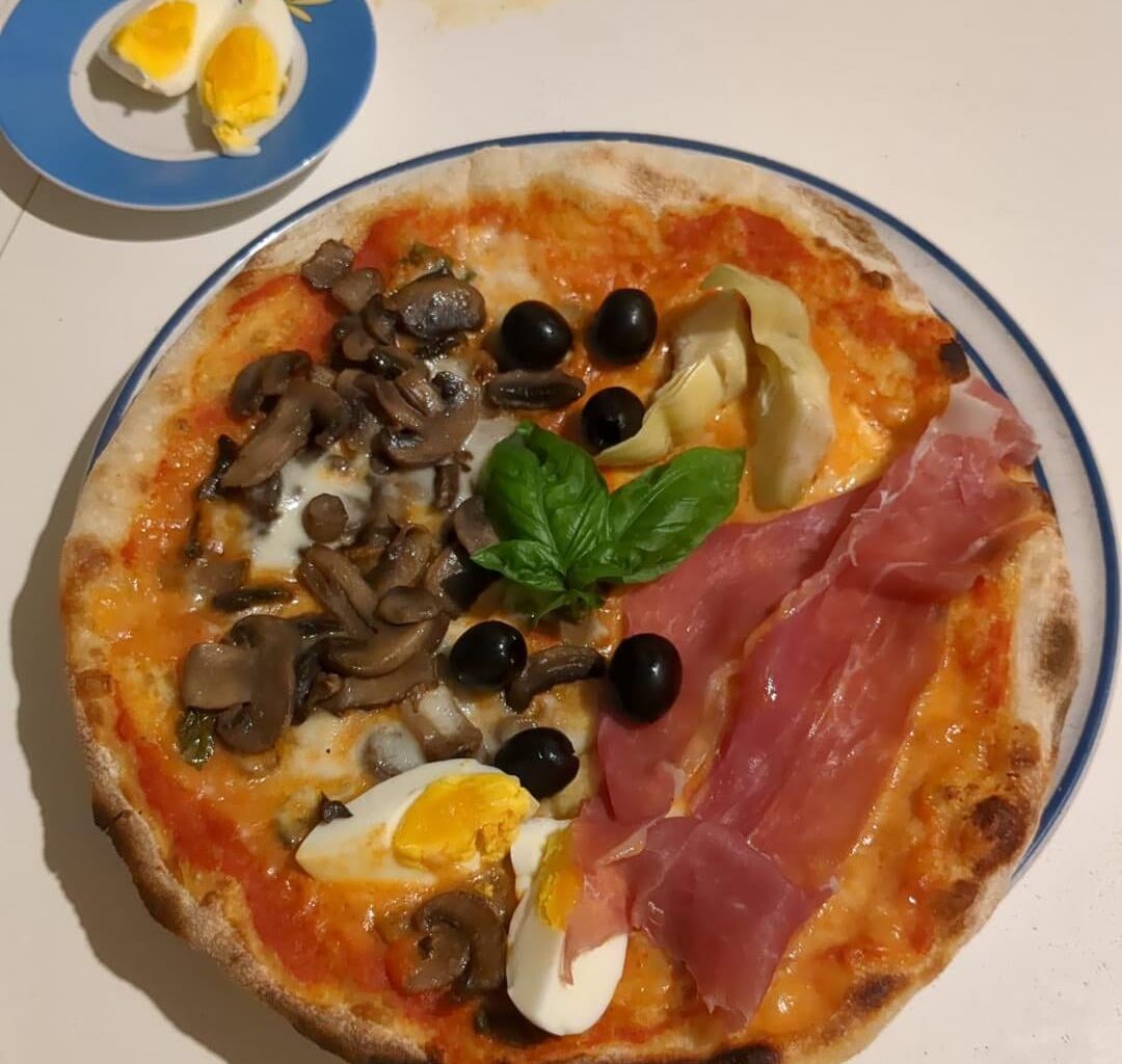 The good old pizza capricciosa: Prosciutto di Parma, Artichoke, Eggs, Mushrooms, Mozzarella, Cherry tomatoes sauce.