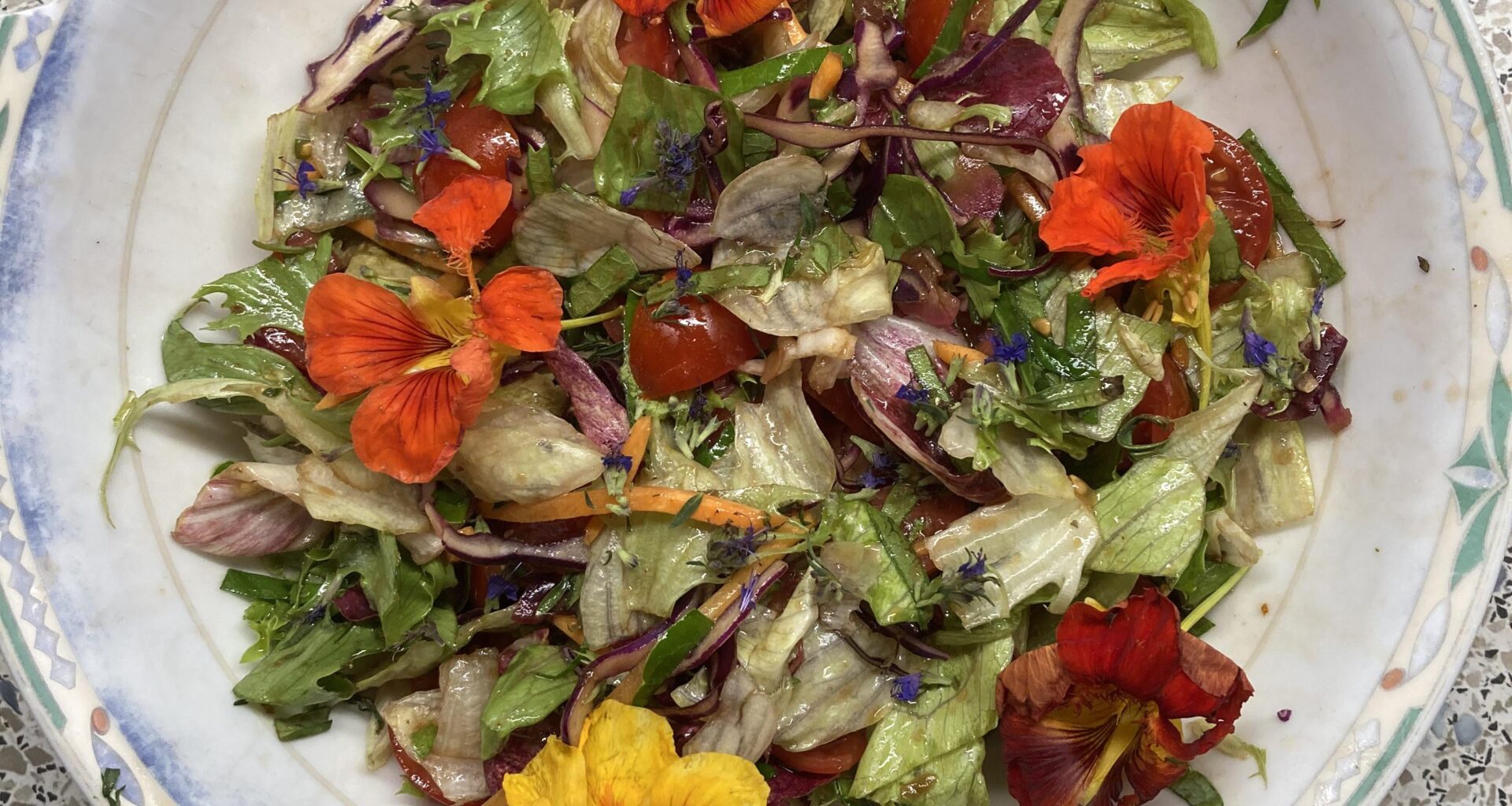 Simple salad with freshly harvested tomatoes & herbs & blossoms from the garden