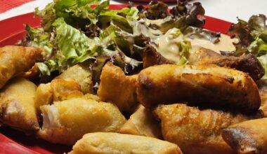 Chnusperli (breaded strips of perch fillet) and small spring rolls, both fried in the hot-air fryer, served with a homemade dip and Batavia lettuce