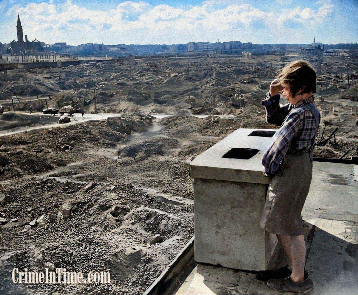 A little girl is overlooking the ruins of Warsaw. Her identity is a mystery; she might be a survivor of the 1944 Uprising. The cars in the background have brought ex-US President Herbert Hoover to the location, as part of his post-war relief effort. Hoover's photographer R. Kenny took the picture.