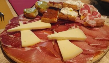 An appetizer with local cheese, salami and bruschette
