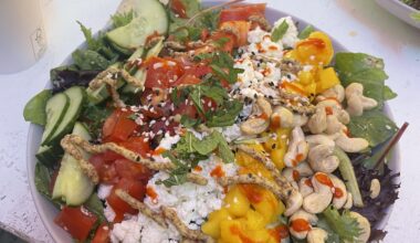 Salad with cucumber, tomato, feta, mango, and cashews