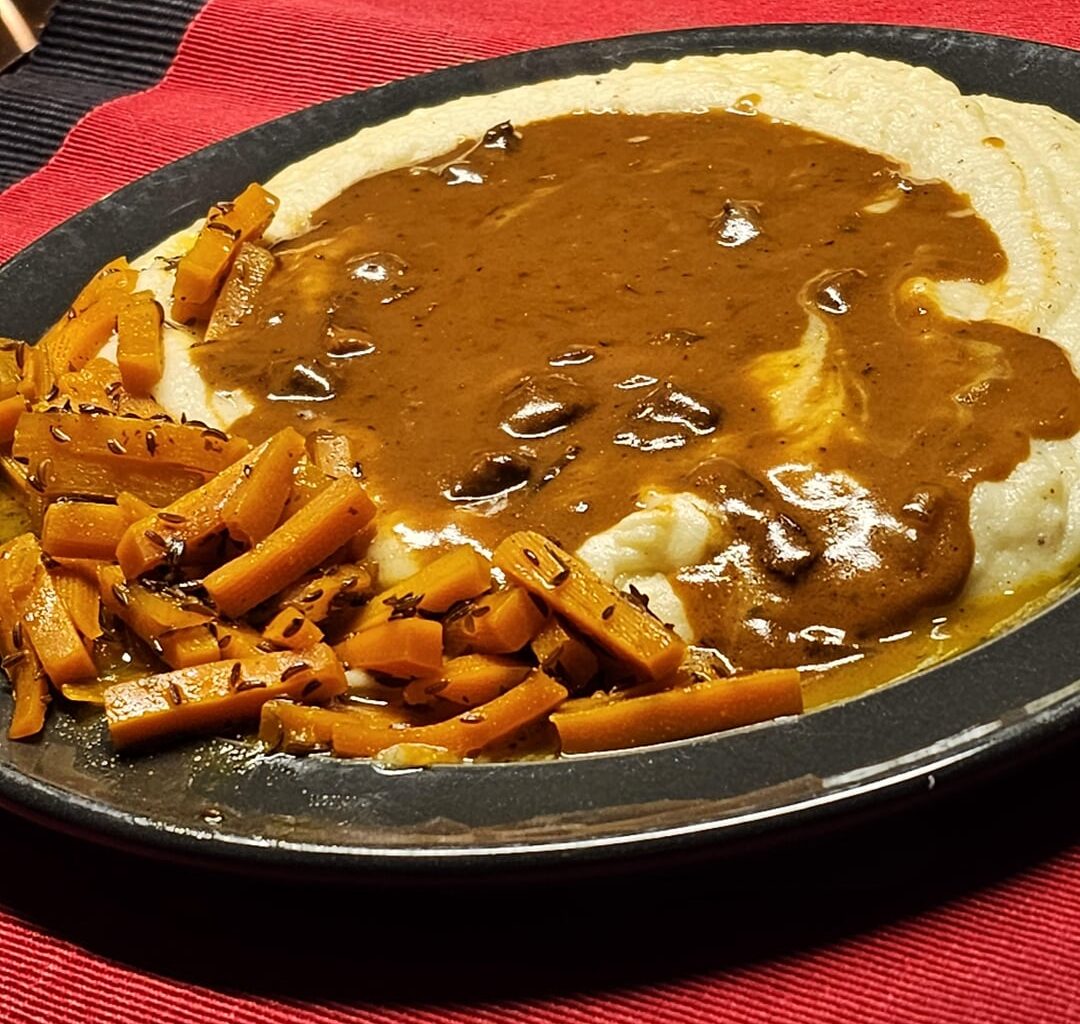 Meatballs in a creamy onion and bacon sauce, served with glazed caraway carrots and homemade mashed potatoes