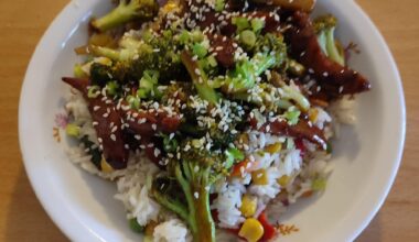 Stir fried broccoli and sausage over rice and veggies