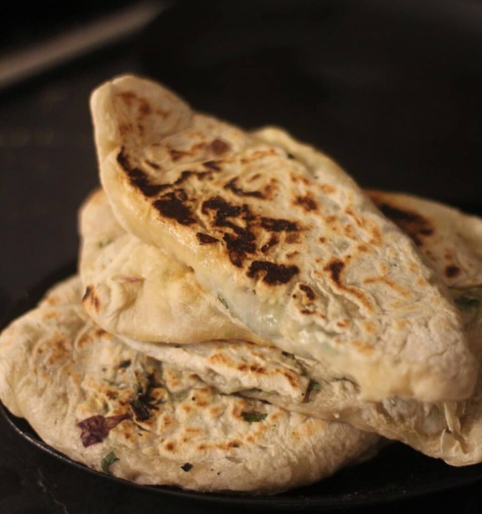 Zhingyalov hats (flatbread stuffed with finely diced herbs and green vegetables. It is a traditional dish of Armenians from Artsakh and Syunik and has traditionally been a staple in times of scarcity, such as famine and war).