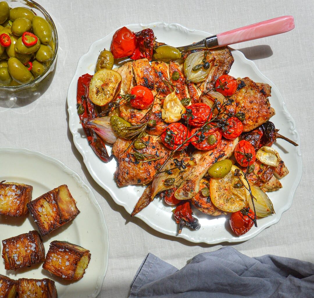 Roasted chicken with cherry tomatoes, green olives, capers and lemon served with ultra crispy potato layers and gorgonzola-based dip
