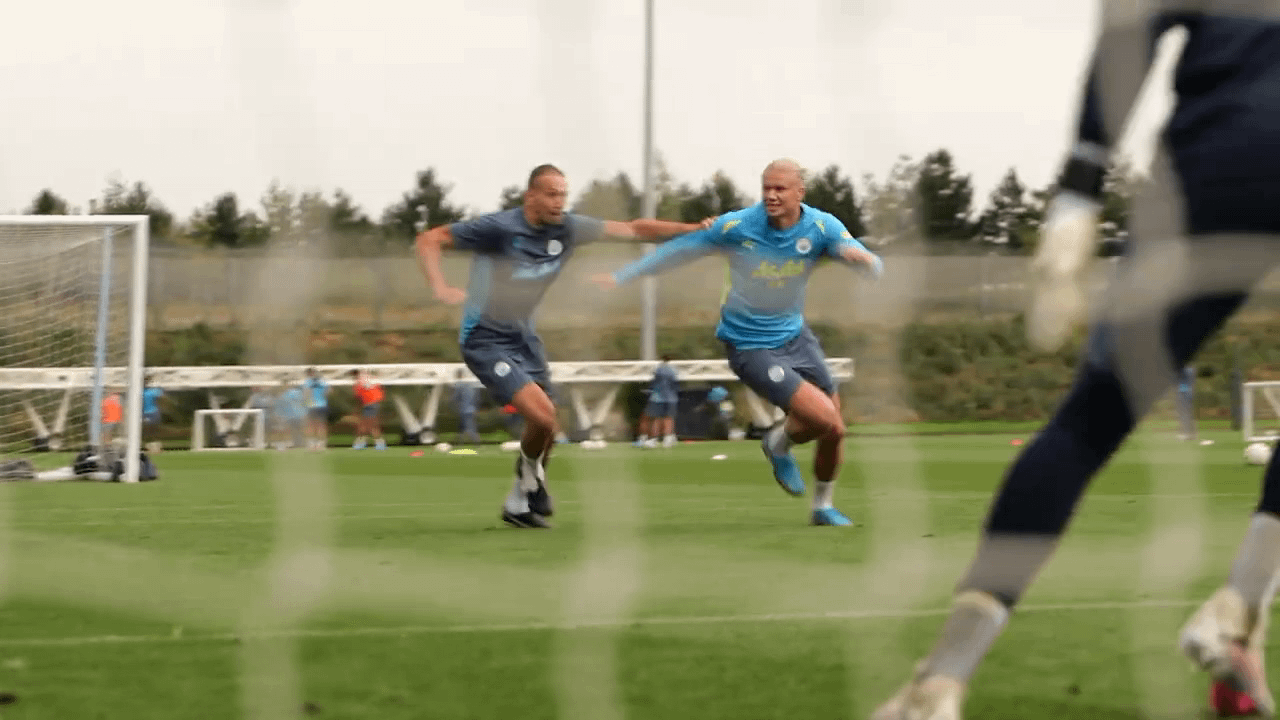 Haaland in training while Pep cheers.