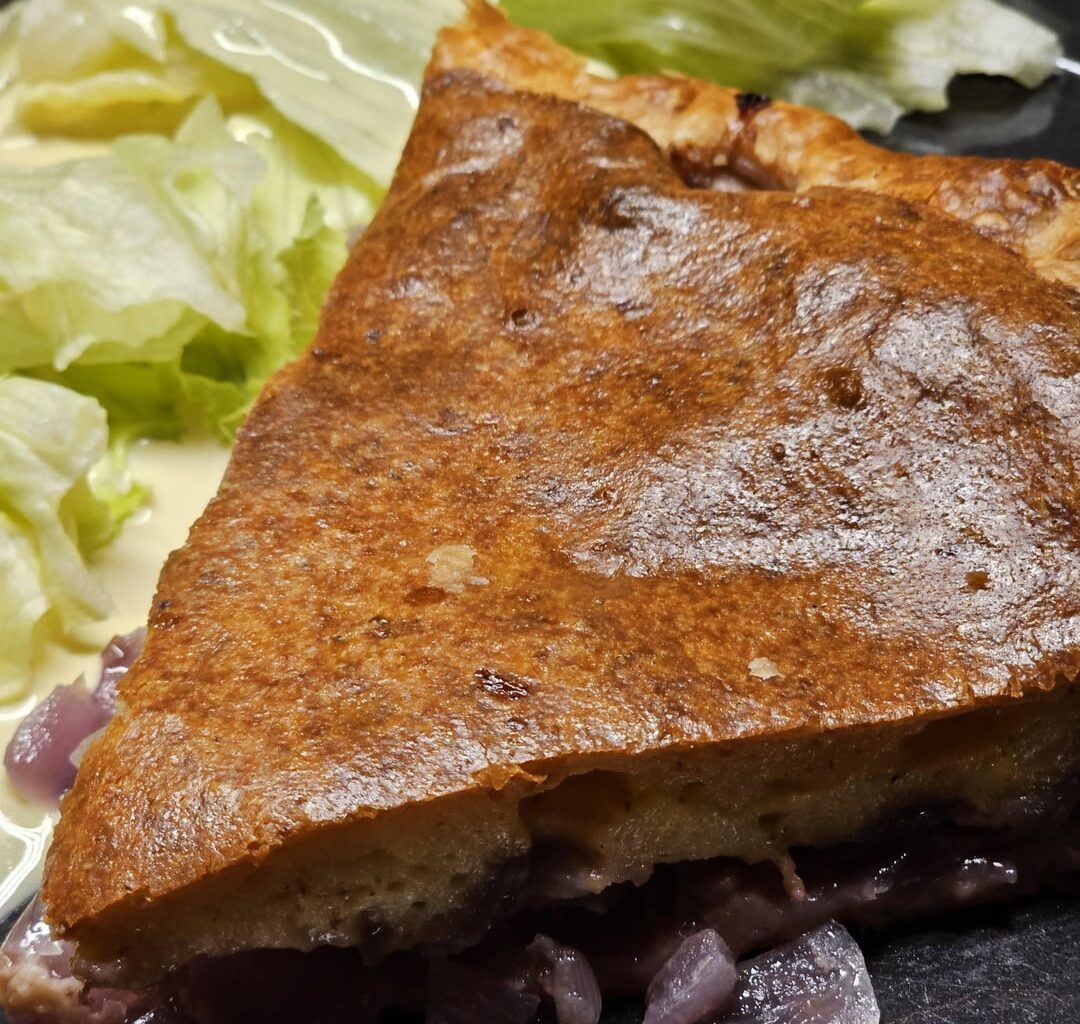 Typical Swiss onion and cheese tart, using a ready-made fondue mix obtained directly from the manufacturer