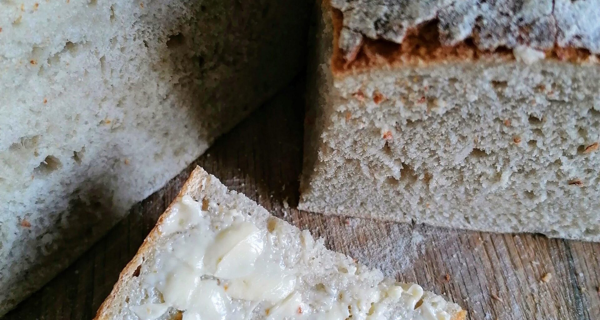 freshly baked sourdough bread, the first slice with butter&salt