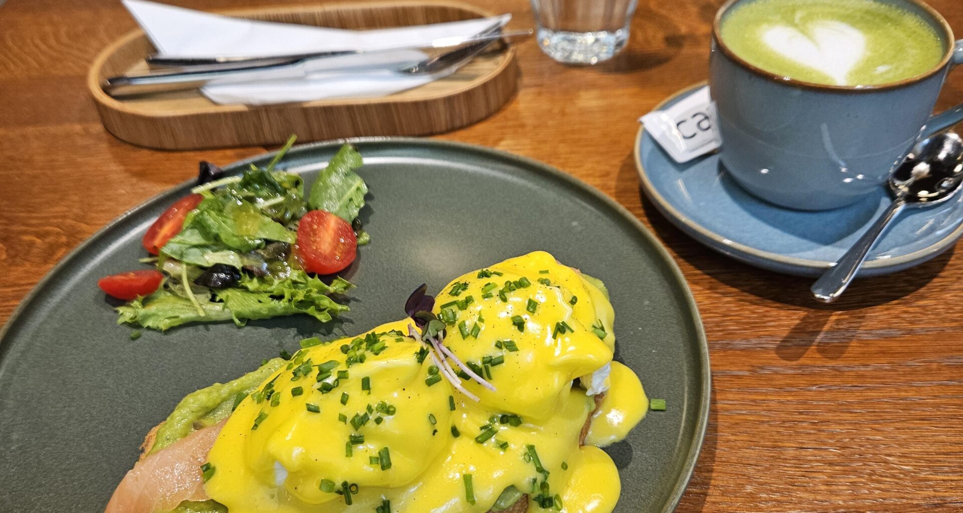 Egg Benedict with avocado and salmon and Matcha Latte in Plzeň, Czech Republic