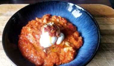 Pappa al pomodoro with basil oil, toatsed pine nuts and burrata