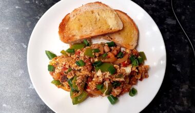Scrambled eggs with bacon, onion, peppers and tomatoes