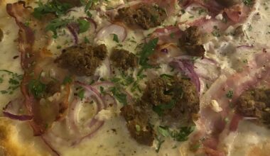 loosely based on flammkuchen - flatbread with white truffle cream base, mozzarella, pancetta, garlic, onion, sausage & herbs
