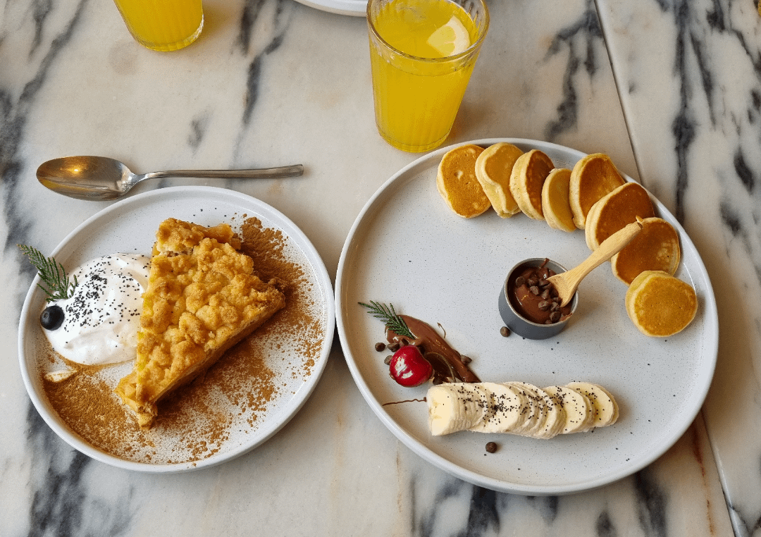 Brunch in Lisbon. Pancakes and apple crumble with greek yogurt