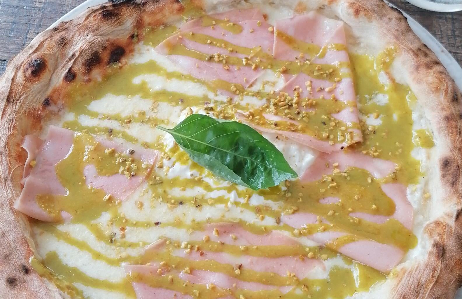 White sauce pizza with pistachio