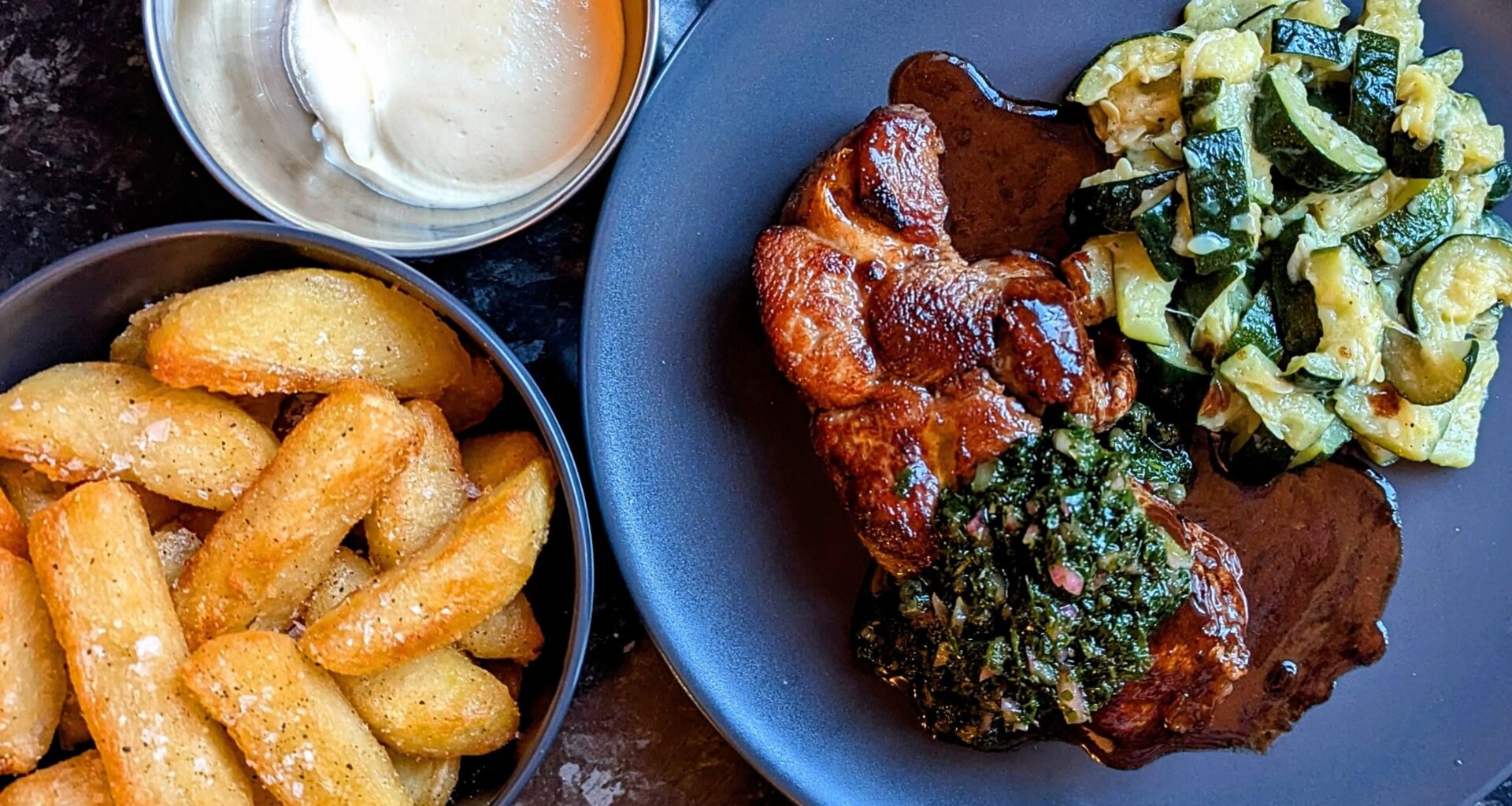 Lamb steak with green sauce and very unfashionable but delicious mushy courgettes, + chips and aioli