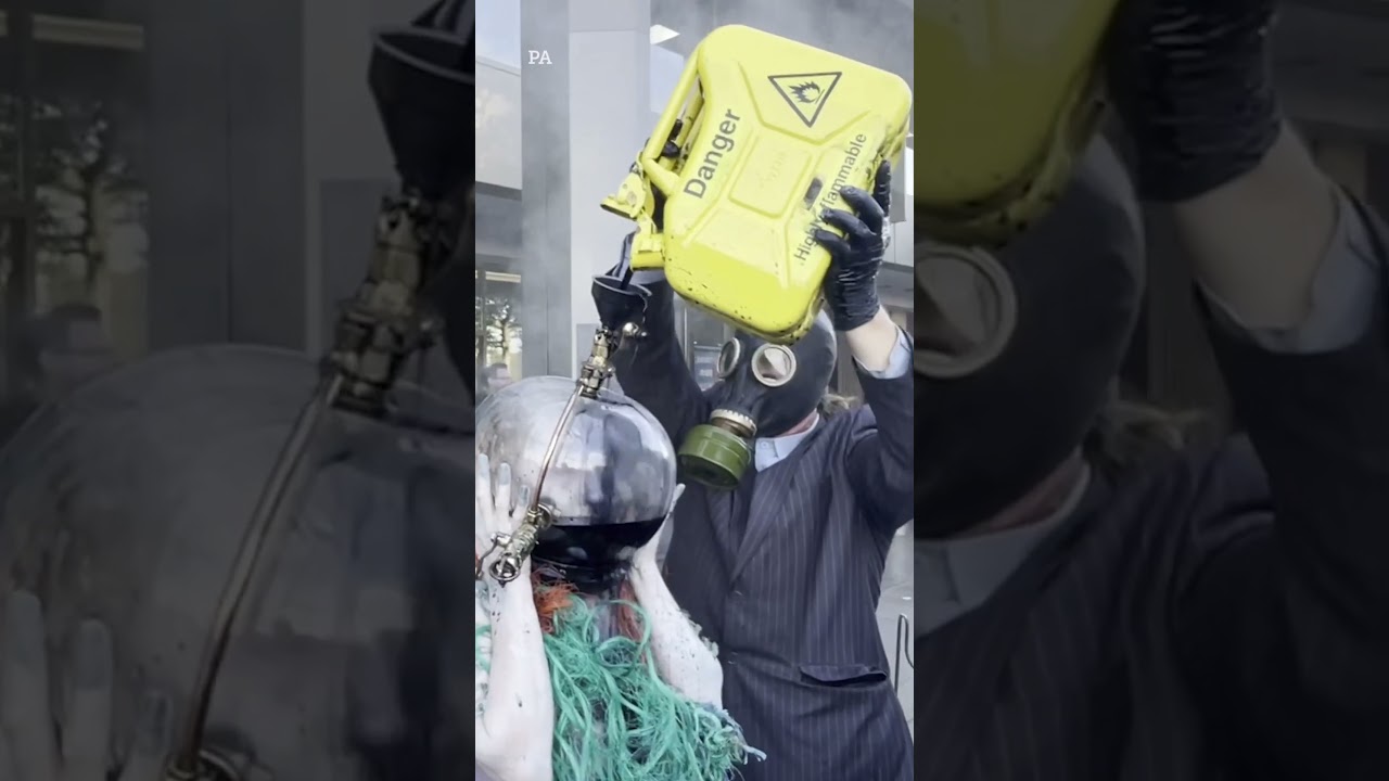 Ocean Rebellion stage performance protest showing sea goddess drowning in fishbowl helmet