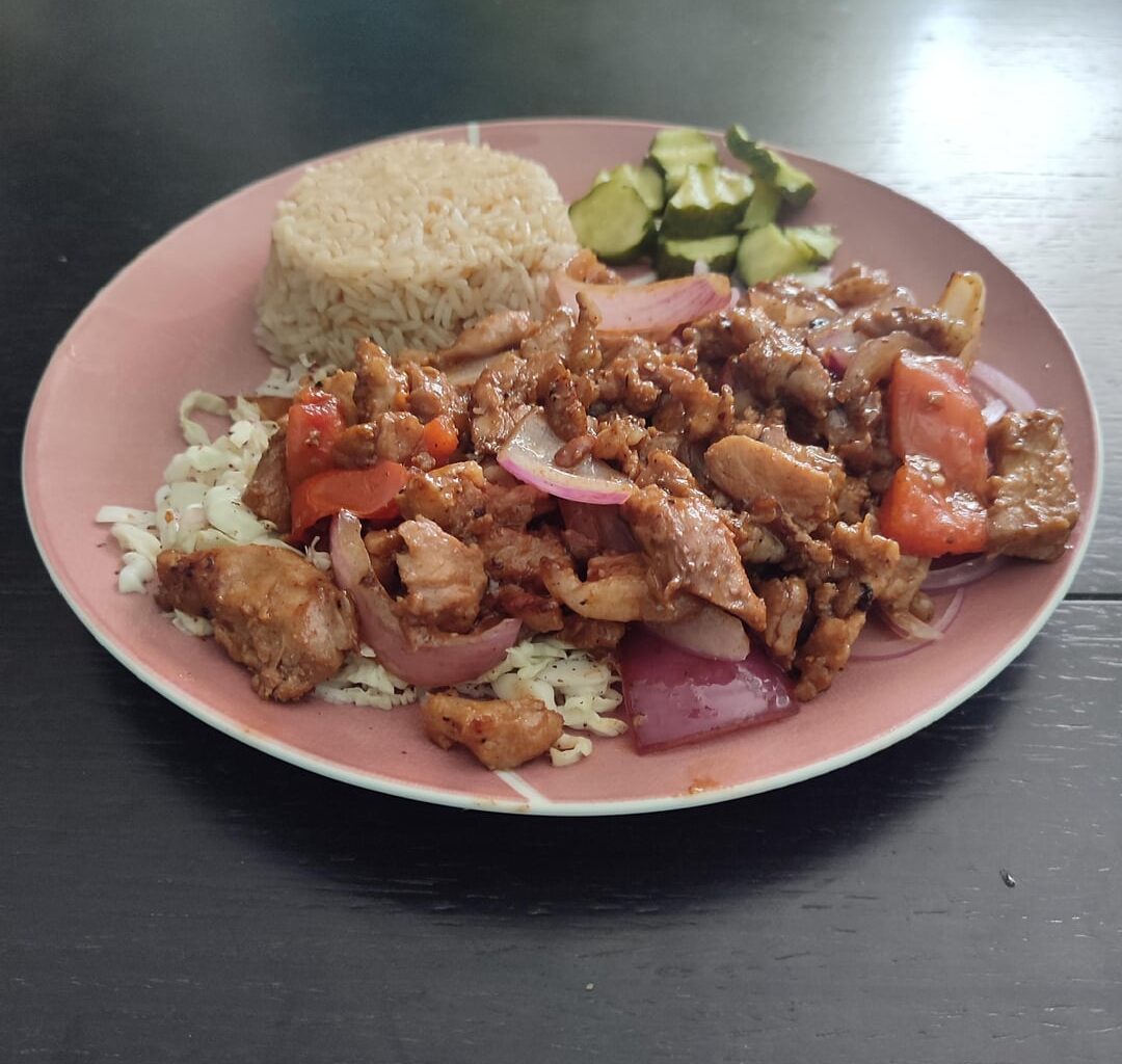 Pork cooked in its own juices and stir-fried, over cabbage, with rice and pickles