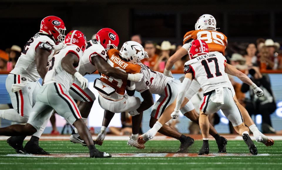 Texas Longhorns running back Quintrevion Wisner (26) is brought down by Georgia defense in the second quarter of the Longhorns' game against the Georgia Bulldogs at Darrell K. Royal Texas Memorial Stadium in Austin, Oct. 19, 2024.