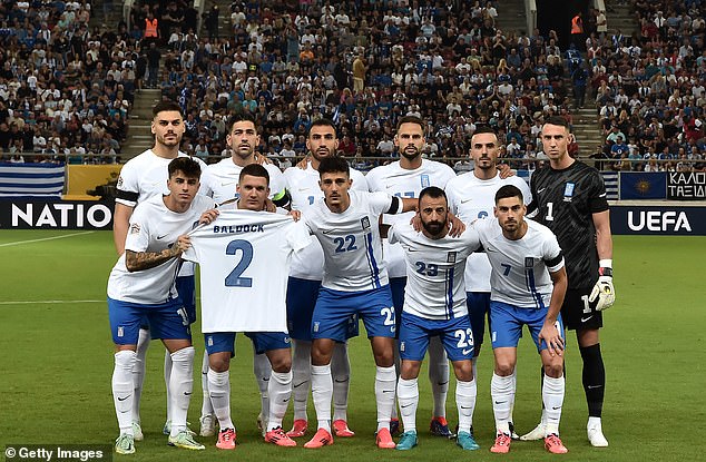 Greece's players pictured posing for a pre-match team photo ahead of thier game against Ireland, while displaying the shirt of the late George Baldock following his death aged 31