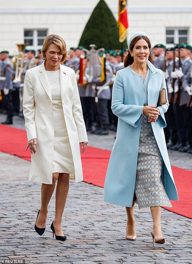 Queen Mary of Denmark beamed as she walked alongside Lady Elke Büdenbender in Berlin today