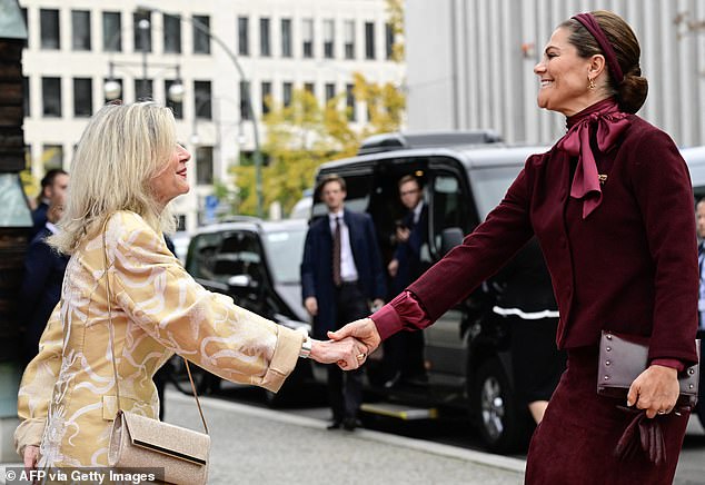Also in attendance was Veronika Wand-Danielsson, Sweden's ambassador to Germany (left), who curtsied as she greeted Victoria