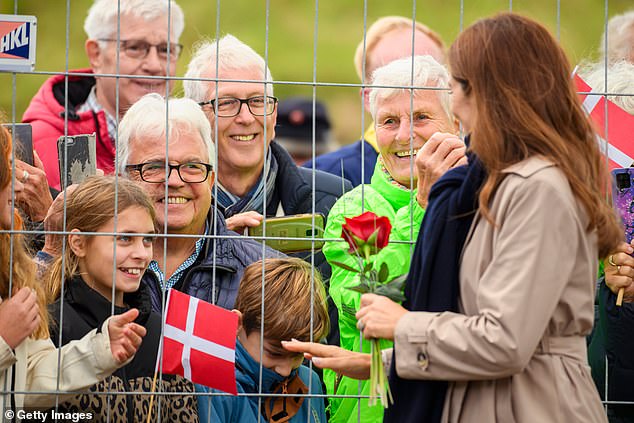 Young royal fans with Danish flags beamed as Mary approached and greeted them