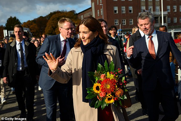 Mary smiled as she waved to the crowds while Frederik appeared in equally good spirits